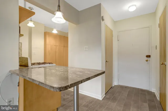 a bathroom with a granite countertop sink and mirror