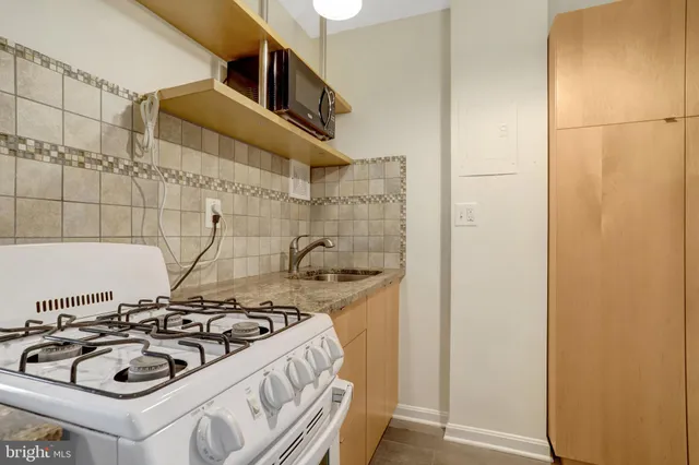 a kitchen with a sink a stove and refrigerator