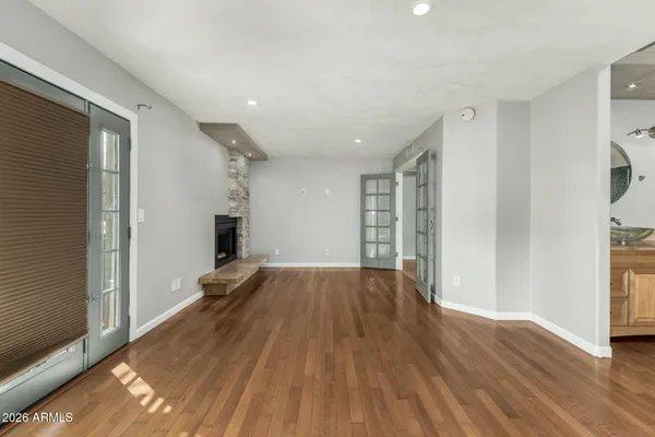 a view of empty room with wooden floor