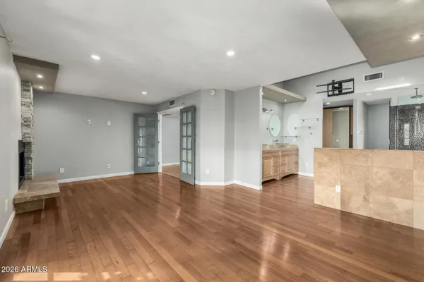 a view of an empty room with wooden floor