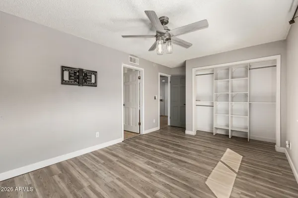 a view of a livingroom with wooden floor and closet area