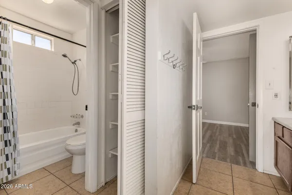 a bathroom with a granite countertop shower a toilet and a sink
