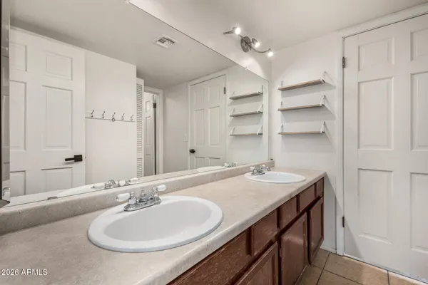a bathroom with a sink double vanity and a mirror