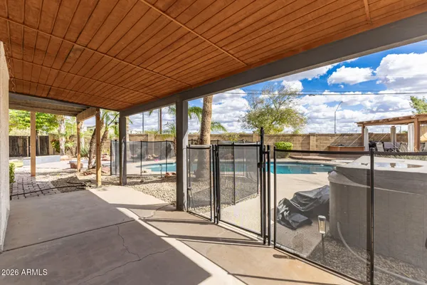 a building view with a floor to ceiling window next to a yard