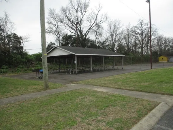 a view of a livingroom with furniture and a book shelf