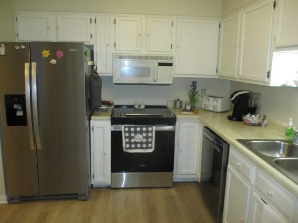 a kitchen with a refrigerator and cabinets