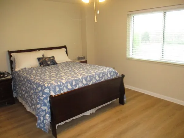 a bed sitting in a bedroom next to a window