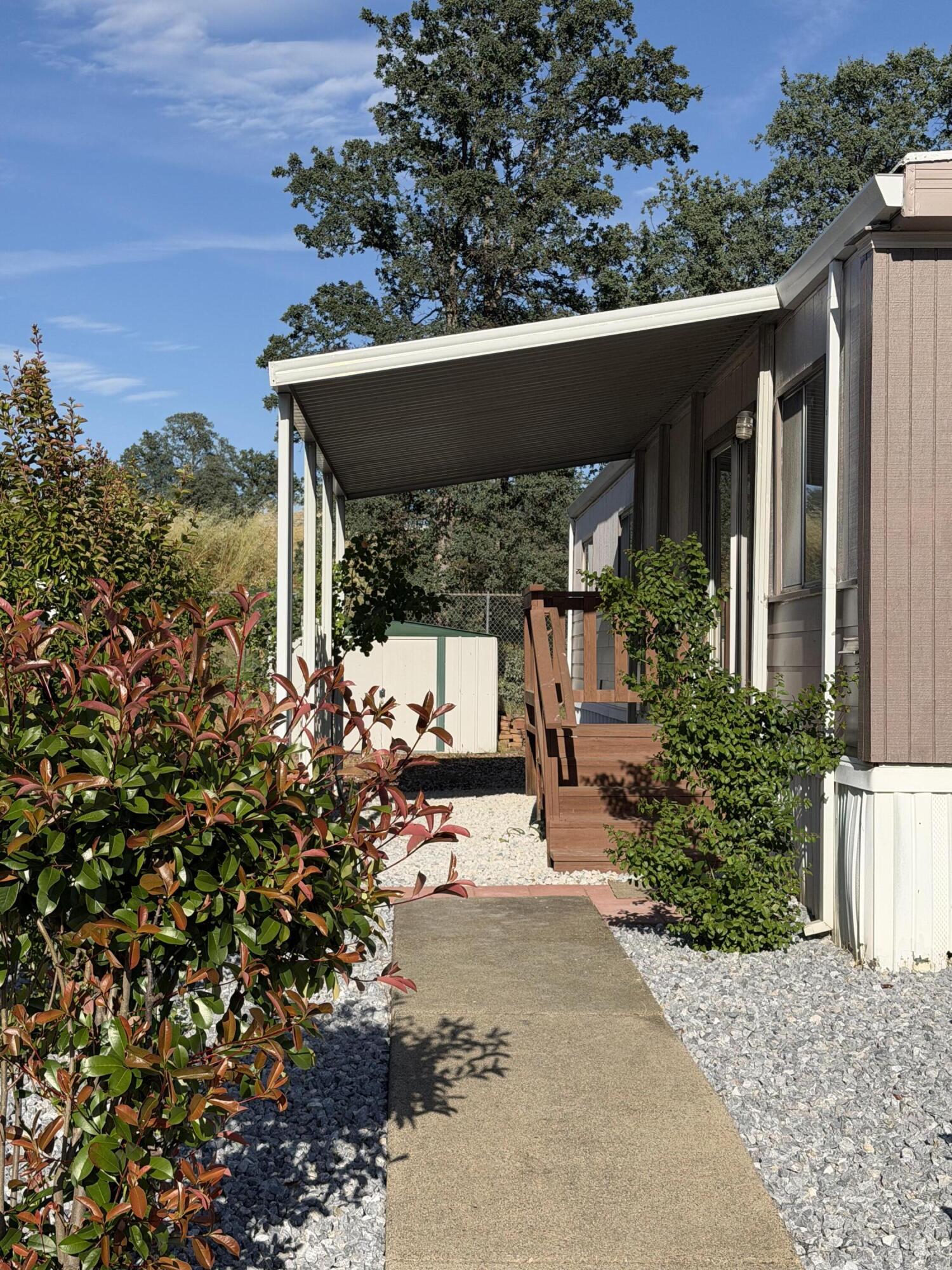 1449 Menomenee Lane, Unit 252 Redding, CA 96003 - Photo 4 of 18 a view of a patio with table and chairs and potted plants
