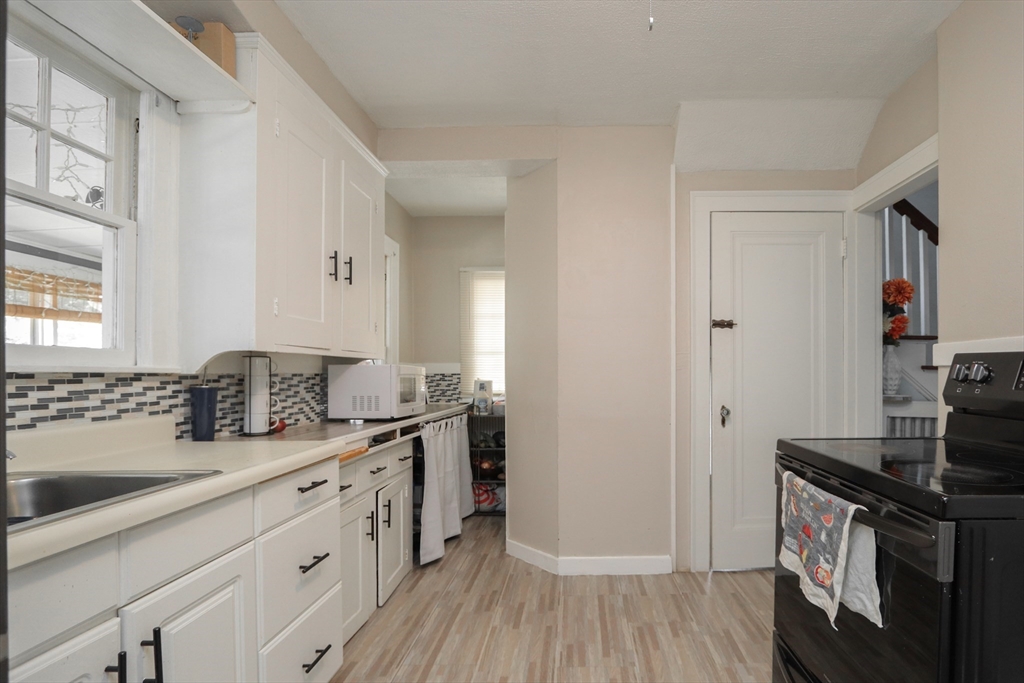 34 Preston Street Springfield, MA 01109 - Photo 11 of 34 a kitchen with a sink stove and cabinets