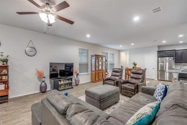a kitchen with stainless steel appliances granite countertop a sink stove microwave and refrigerator