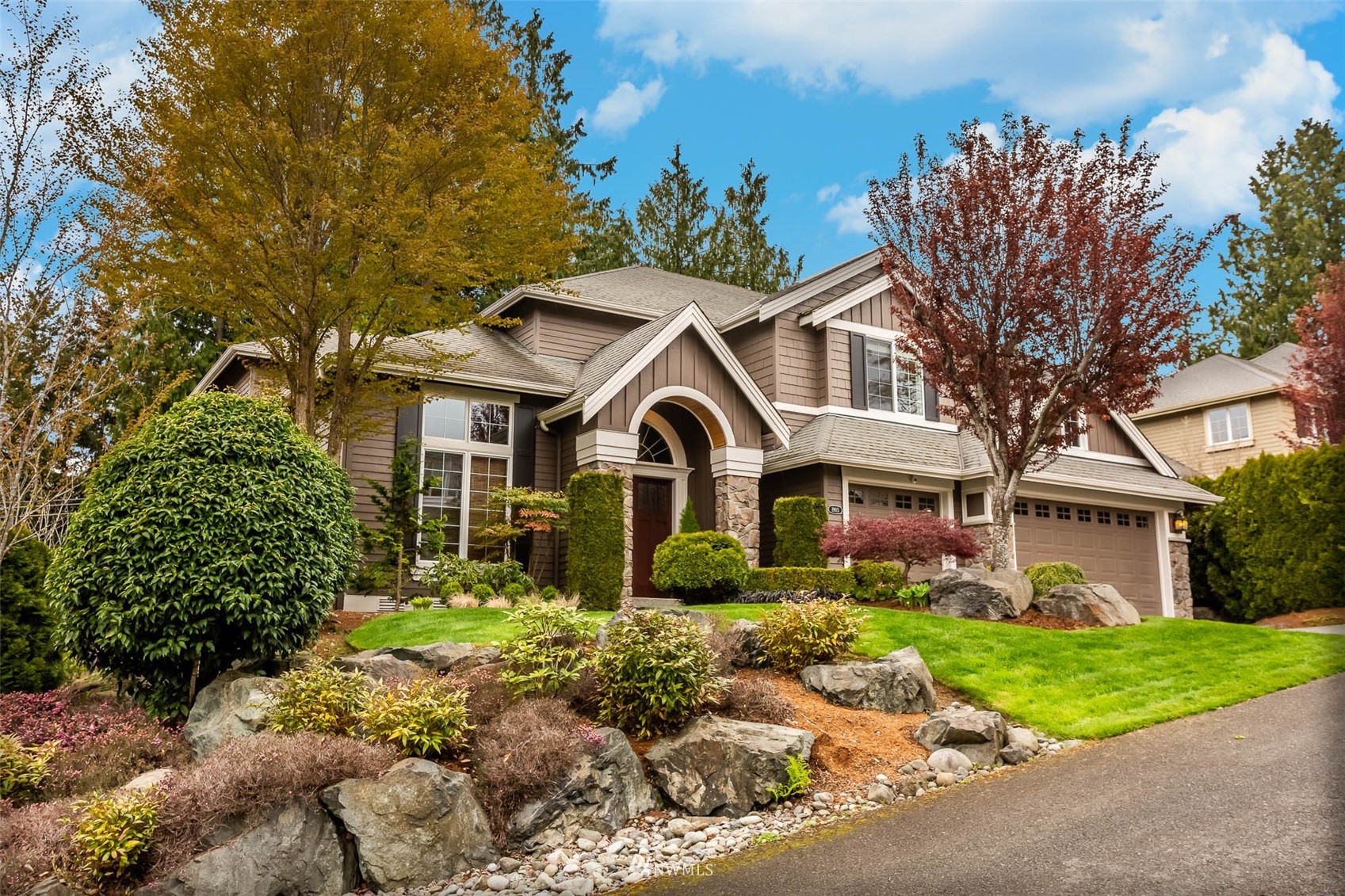 1903 240th Place Southeast Bothell, WA 98021 - Photo 1 of 36 a front view of a house with garden