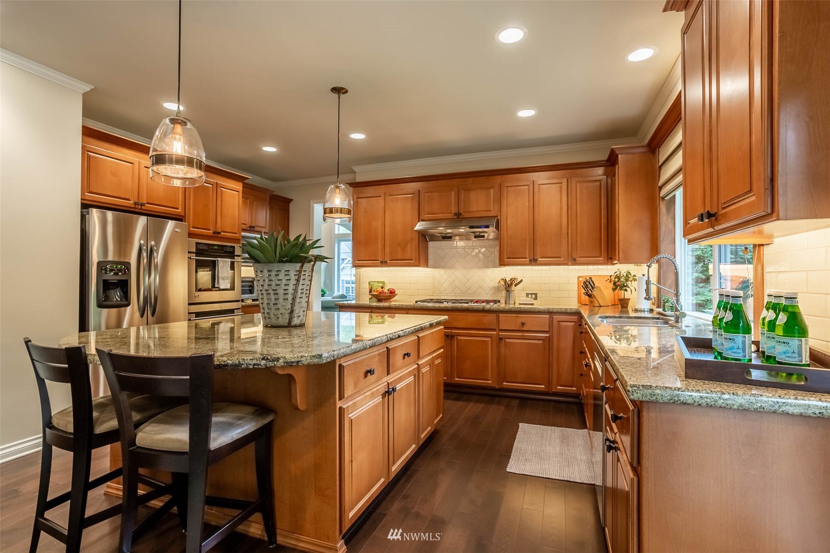 1903 240th Place Southeast Bothell, WA 98021 - Photo 12 of 36 a kitchen with stainless steel appliances granite countertop a sink and a refrigerator