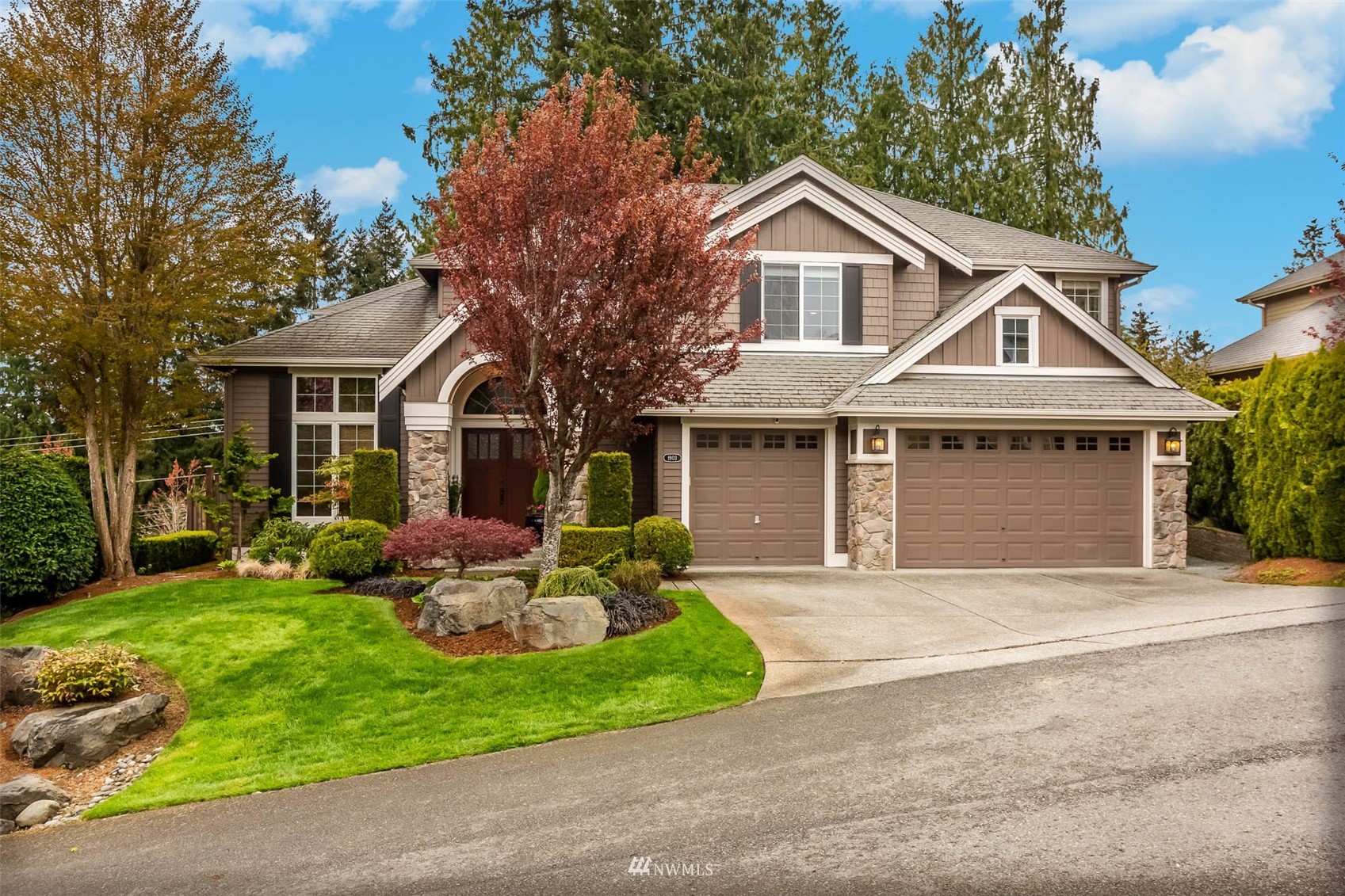 1903 240th Place Southeast Bothell, WA 98021 - Photo 2 of 36 a front view of a house with a yard and garage