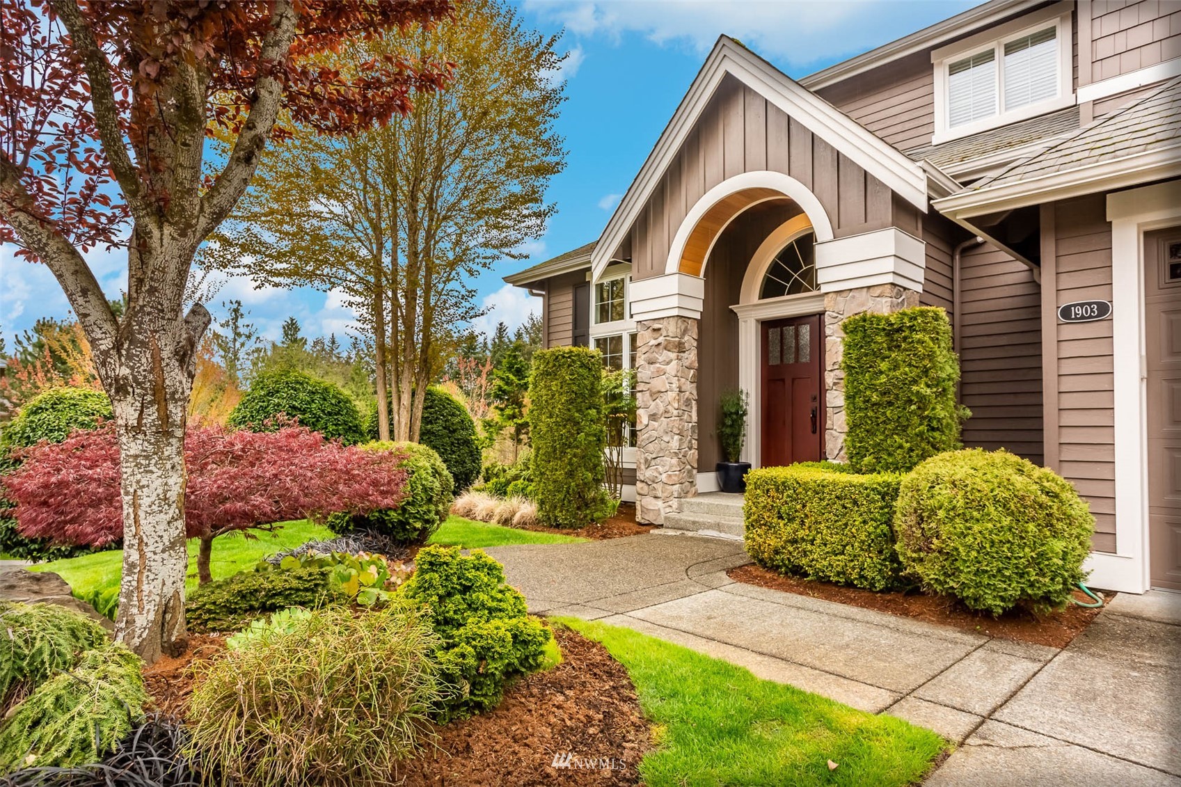 1903 240th Place Southeast Bothell, WA 98021 - Photo 3 of 36 a front view of a house with a yard