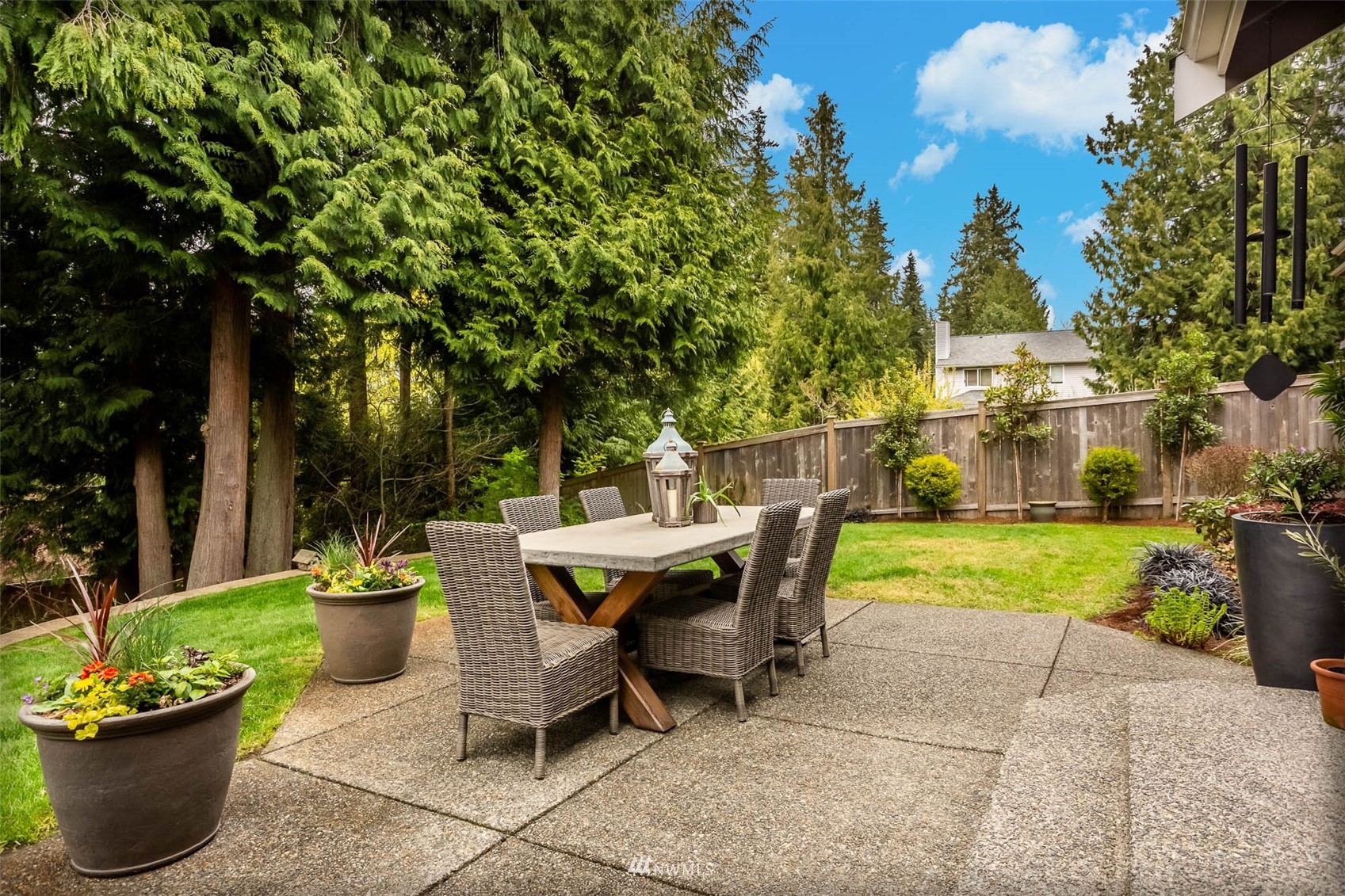 1903 240th Place Southeast Bothell, WA 98021 - Photo 32 of 36 a view of a patio with table and chairs potted plants and a large tree