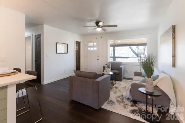a living room with furniture and wooden floor
