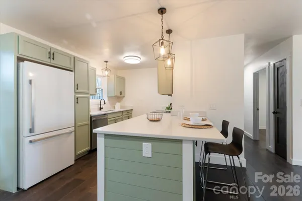 a kitchen with a refrigerator a sink and a stove
