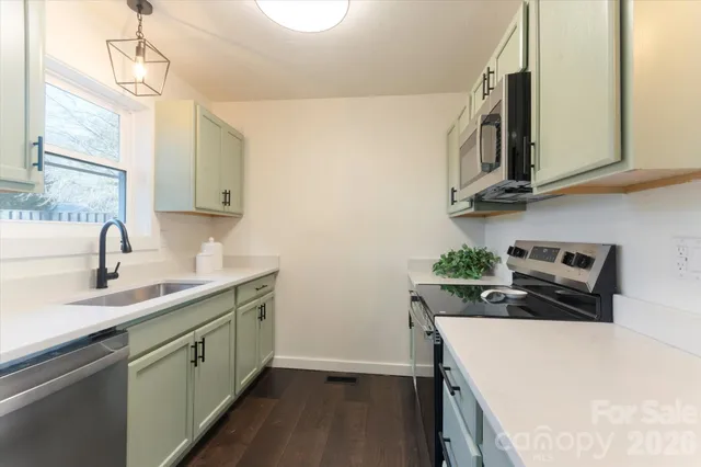 a kitchen with stainless steel appliances a sink a stove and a refrigerator