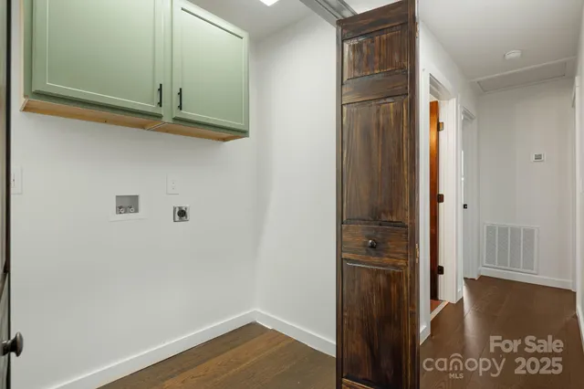 an empty room with a window and wooden floor