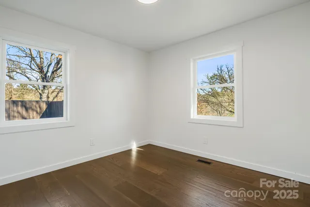 a view of a house with backyard and trees