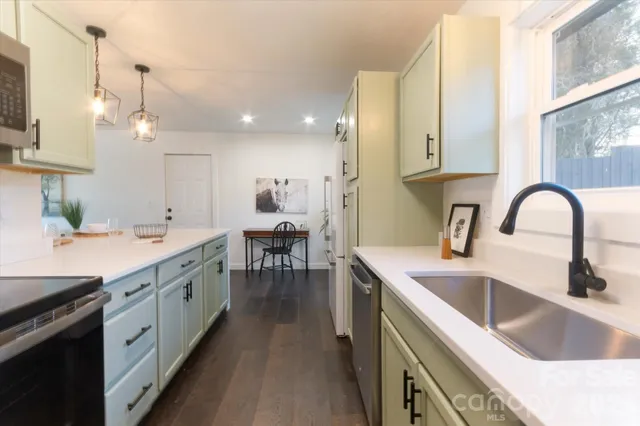 a kitchen with a sink stove and cabinets