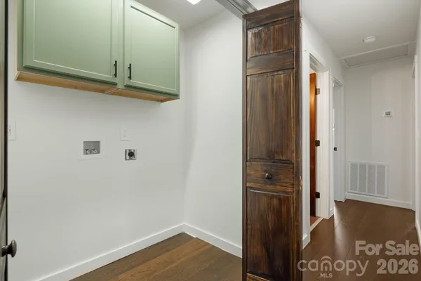 a view of a closet area with wooden floor