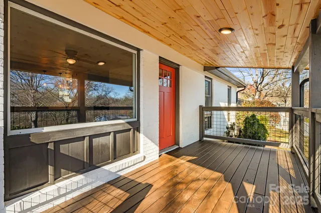 a view of a balcony with wooden floor and outdoor space