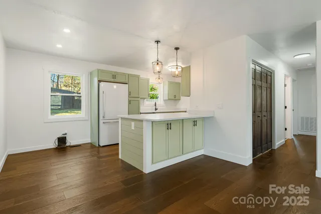 a kitchen that has a sink and a stove in it