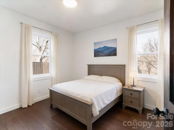 a large bed sitting in a bedroom next to a window