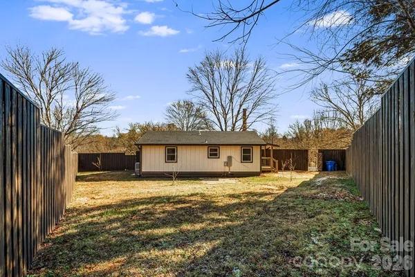 a view of a house with a yard covered in snow