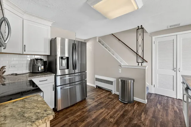 a kitchen with stainless steel appliances a refrigerator sink and microwave