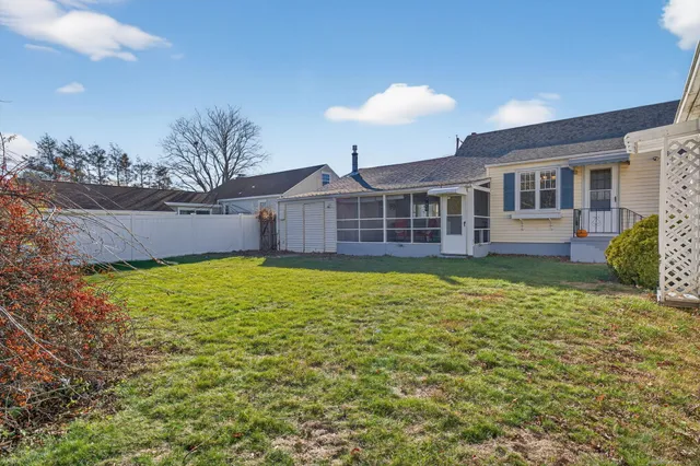 a view of a house with a backyard