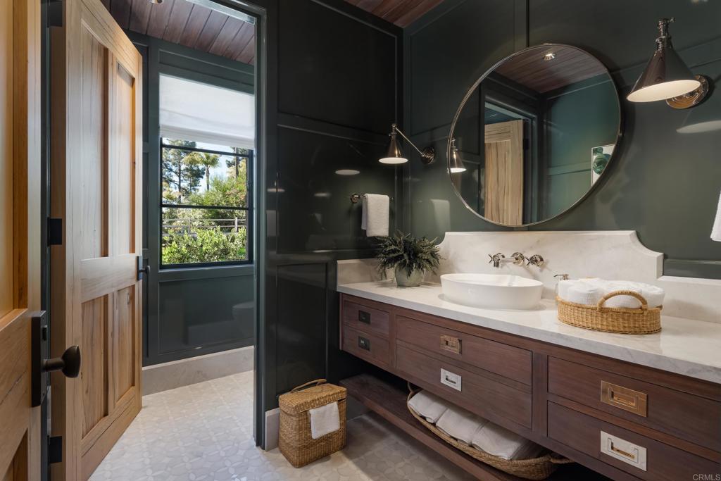 17845 Via De Fortuna Rancho Santa Fe, CA 92067 - Photo 31 of 45 a bathroom with a double vanity sink and a mirror