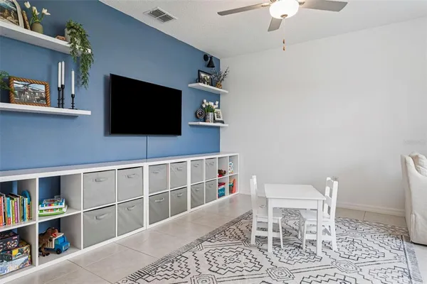 a room with a chair and a flat screen tv