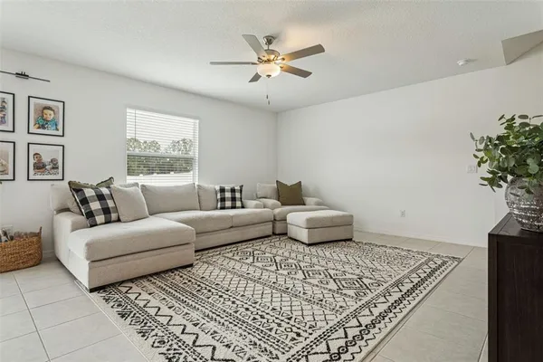 a living room with furniture and a potted plant