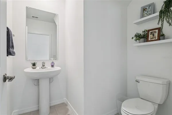 a bathroom with a sink a toilet and mirror