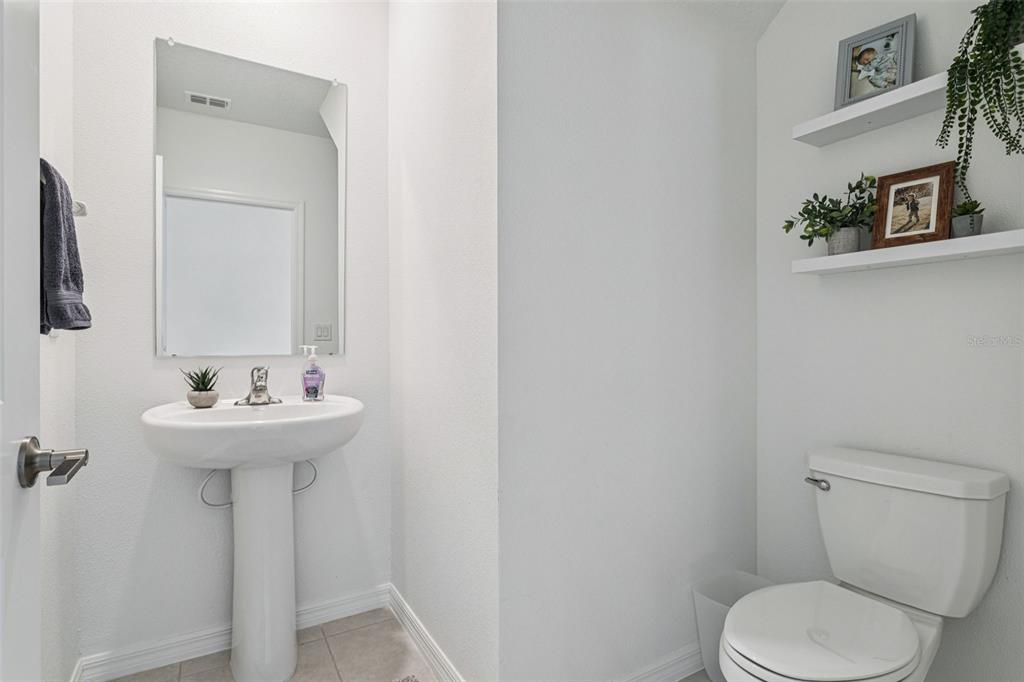 11693 Lavender Loop Spring Hill Spring Hill, FL 34609 - Photo 16 of 34 a bathroom with a sink a toilet and mirror
