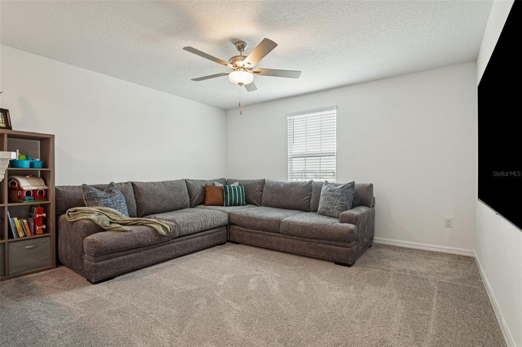 11693 Lavender Loop Spring Hill Spring Hill, FL 34609 - Photo 17 of 34 a living room with furniture and a flat screen tv