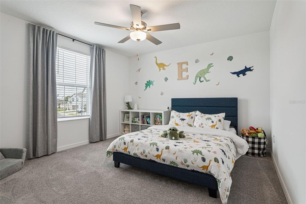 11693 Lavender Loop Spring Hill Spring Hill, FL 34609 - Photo 25 of 34 a bedroom with a bed and a chandelier