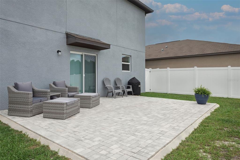 11693 Lavender Loop Spring Hill Spring Hill, FL 34609 - Photo 28 of 34 a backyard of a house with table and chairs