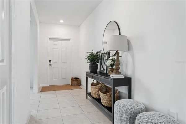 a room with painting on the wall and a potted plant