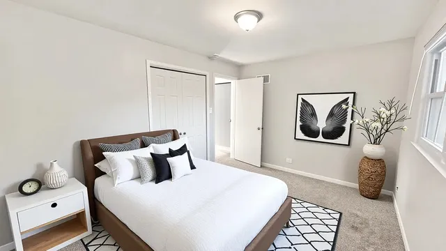 a bedroom with a bed and lamp