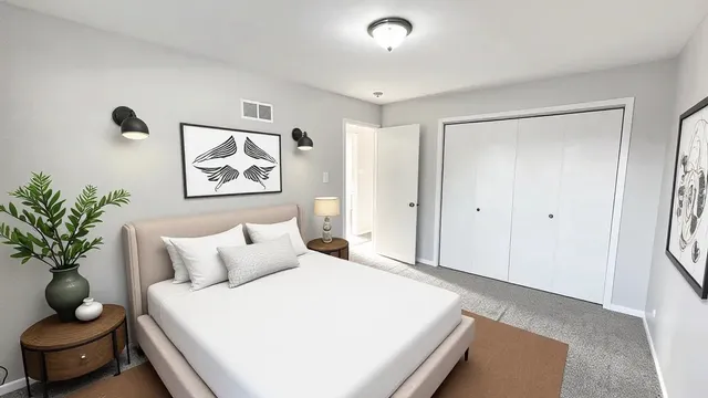 a bedroom with a bed and a potted plant