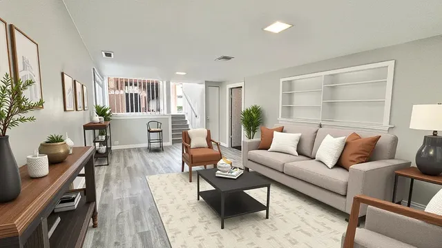 a living room with furniture and wooden floor