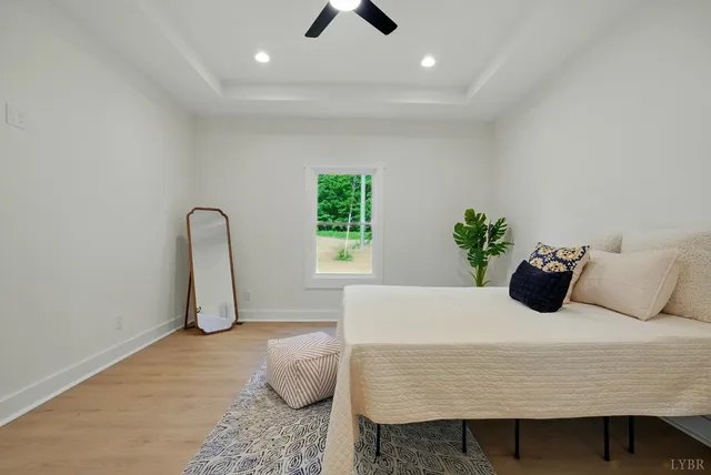 a bedroom with a bed and a ceiling fan
