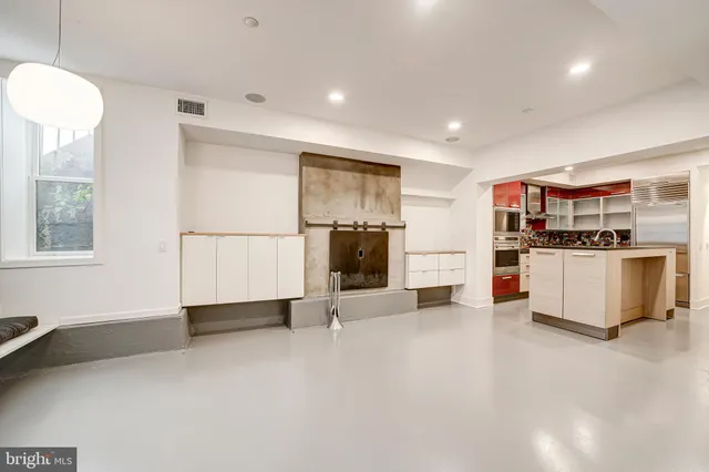a view of kitchen with stainless steel appliances kitchen island a large counter top and a stove top oven