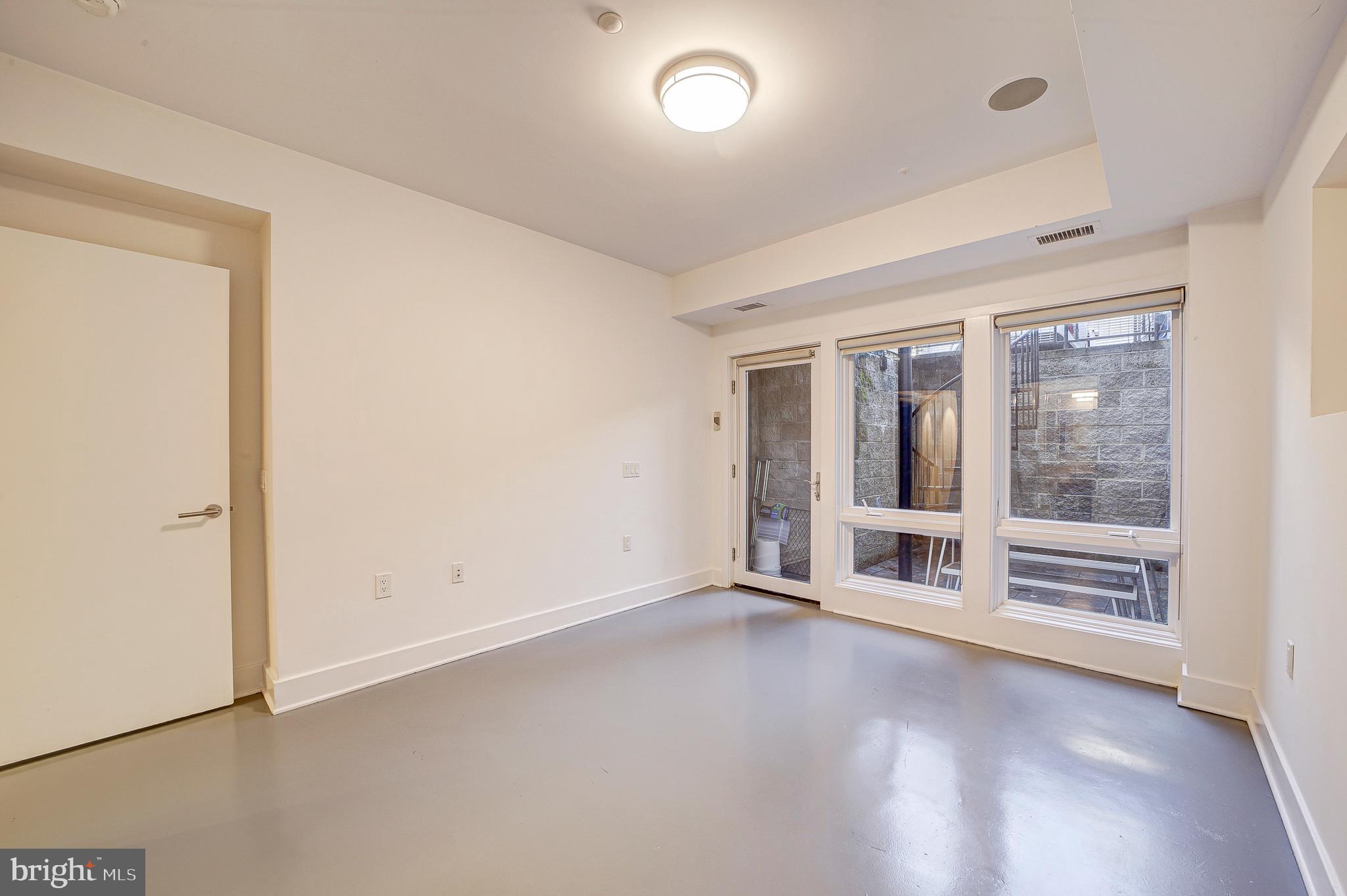 1517 Church Street Northwest, Unit A Washington, DC 20005 - Photo 14 of 23 an empty room with floor to ceiling window and wooden floor