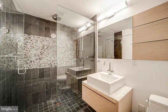 a bathroom with a sink toilet and shower
