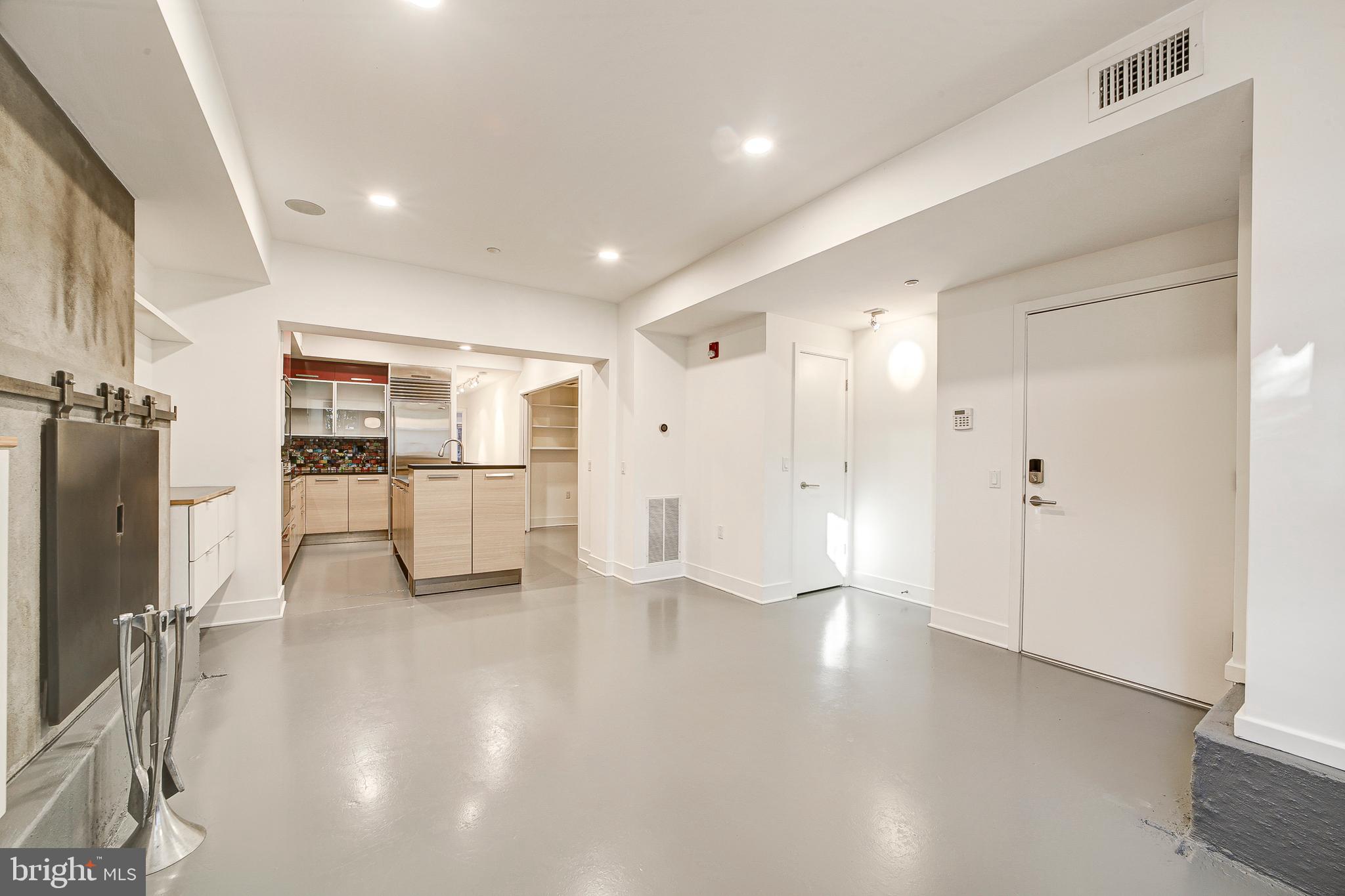 1517 Church Street Northwest, Unit A Washington, DC 20005 - Photo 3 of 23 a view of a kitchen with refrigerator and wooden floor