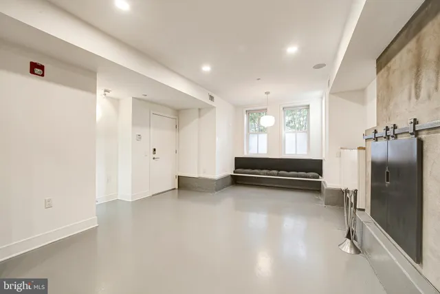 a view of a room with gym equipment and a window
